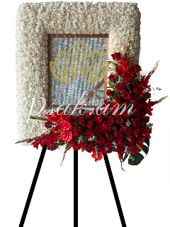 Funeral wreath with a portrait and red flower arrangement